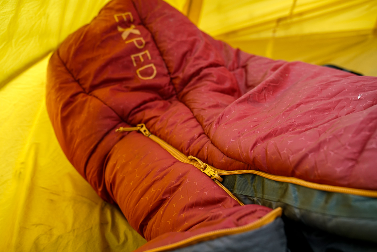 A close up of double zippers at the bottom of a sleeping bag.