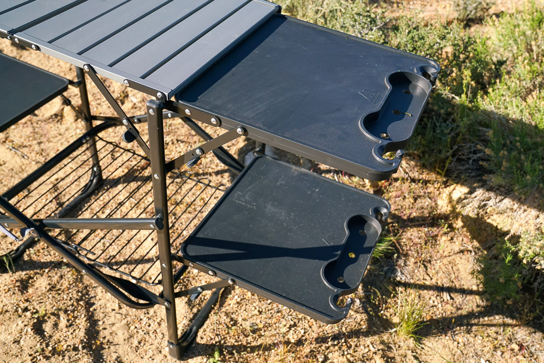A close up of two shelves on a cook station.