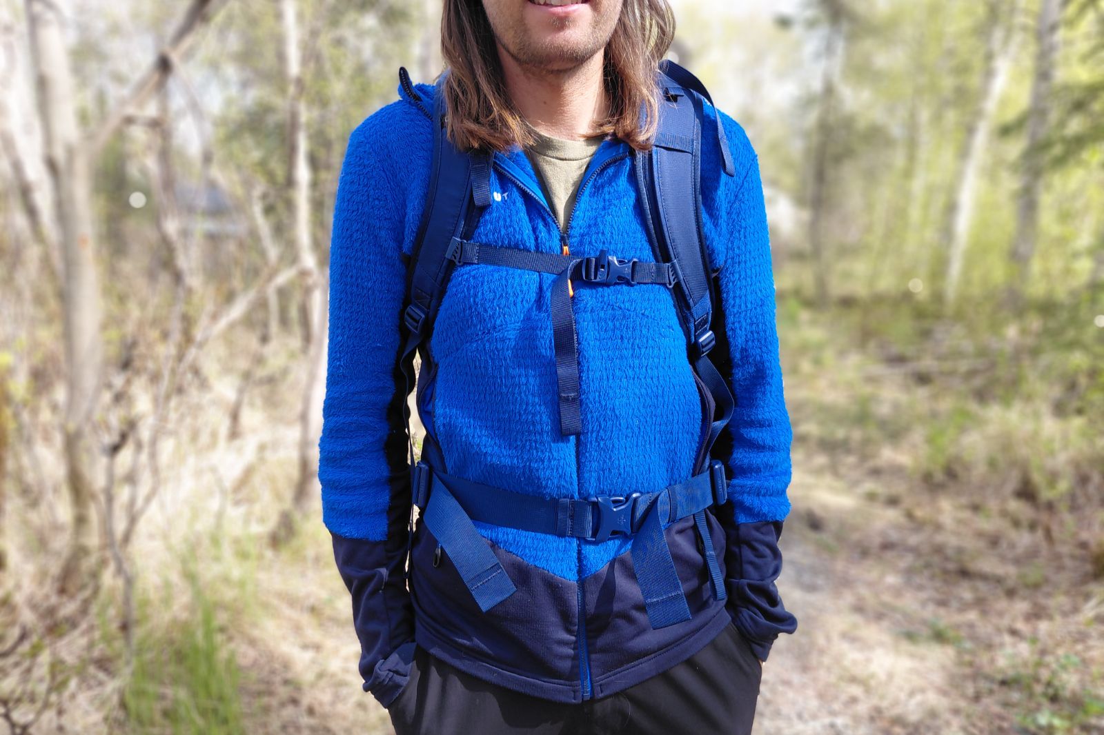 man showing the straps on his travel backpack