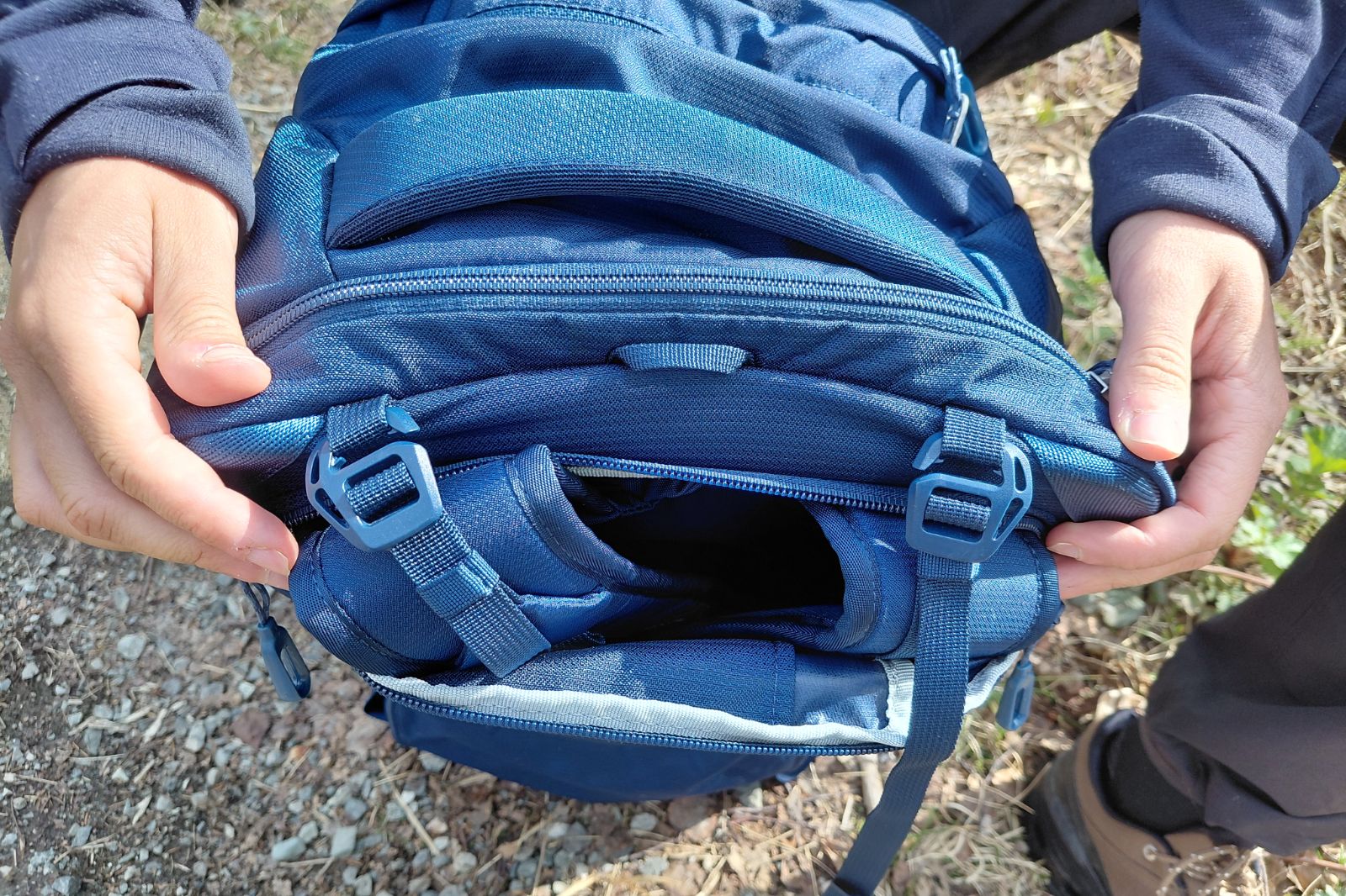 person changing their luggage from a backpack to duffel