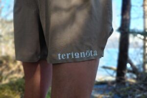 A close-up view of a logo on a pair of shorts.