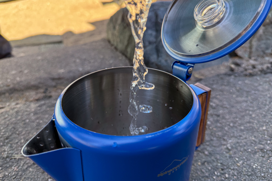 A look inside a coffee percolator after brewing, showing some sediment built up in the device.