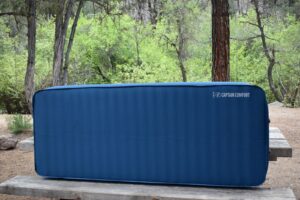 The Captain Comfort propped up against a picnic table shows horizontal air cells that provide comfort and support