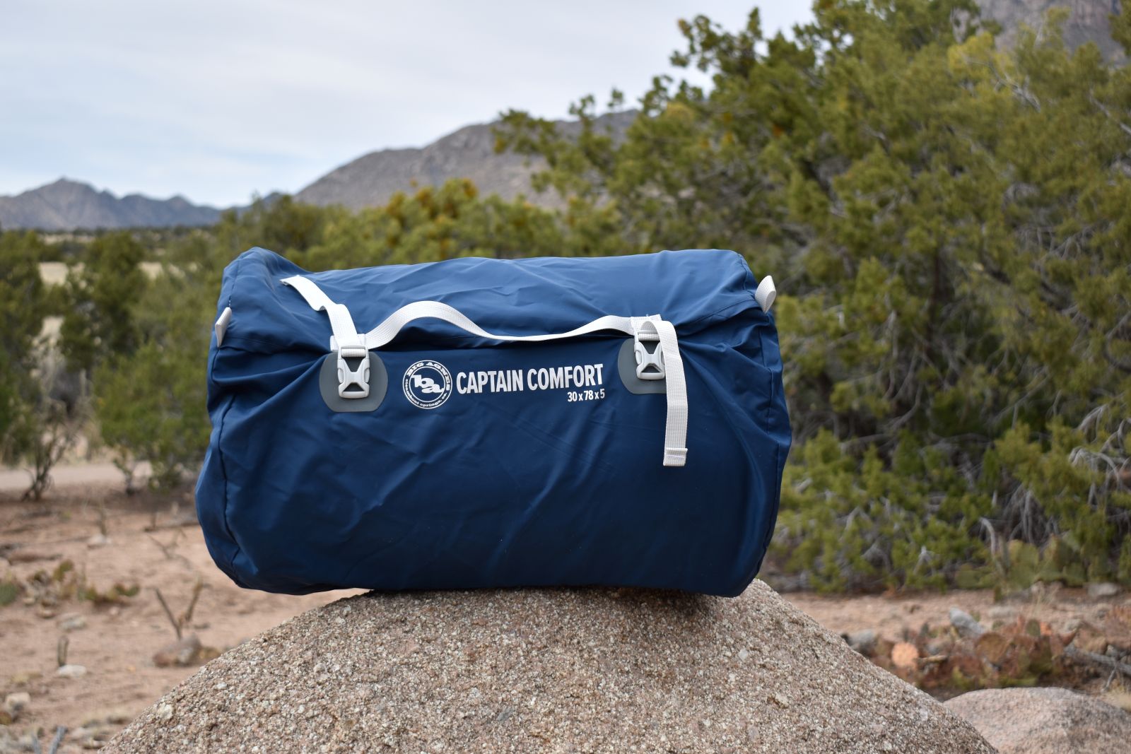 The Captain Comfort in its duffle-style carrying case set on a boulder in the desert