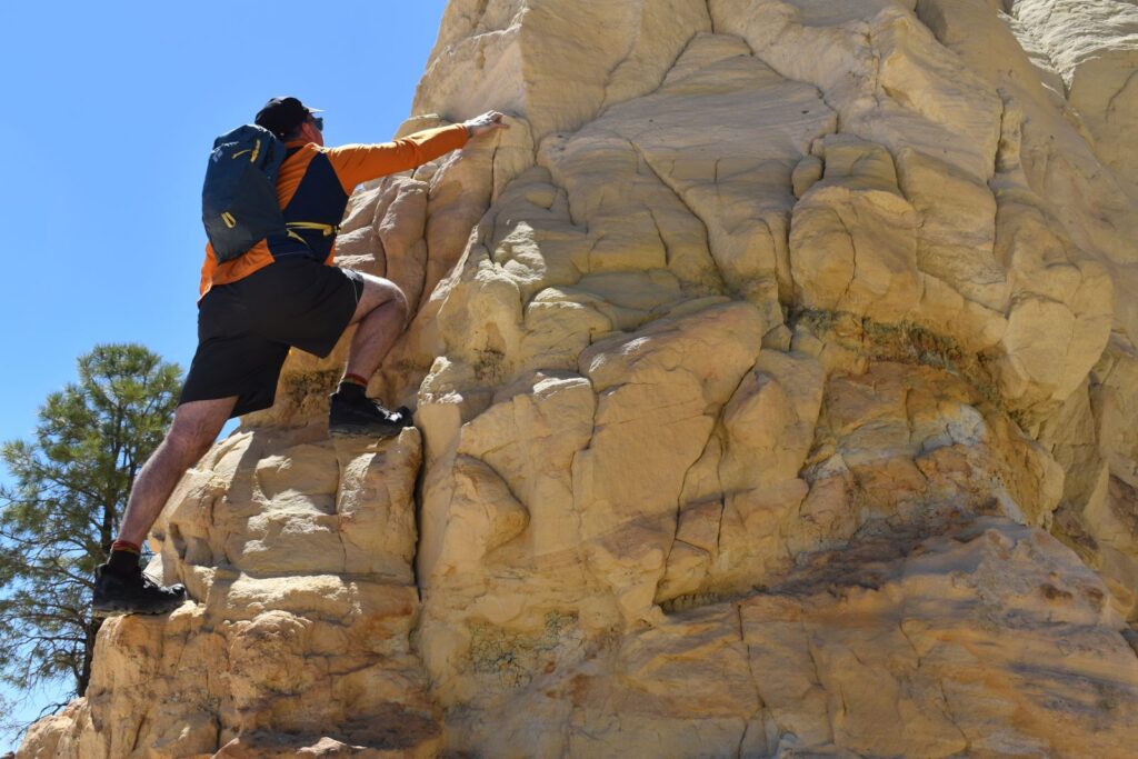 Our male tester scrambles up a volcanic rock formation with the Black Diamond Pursuit on his back
