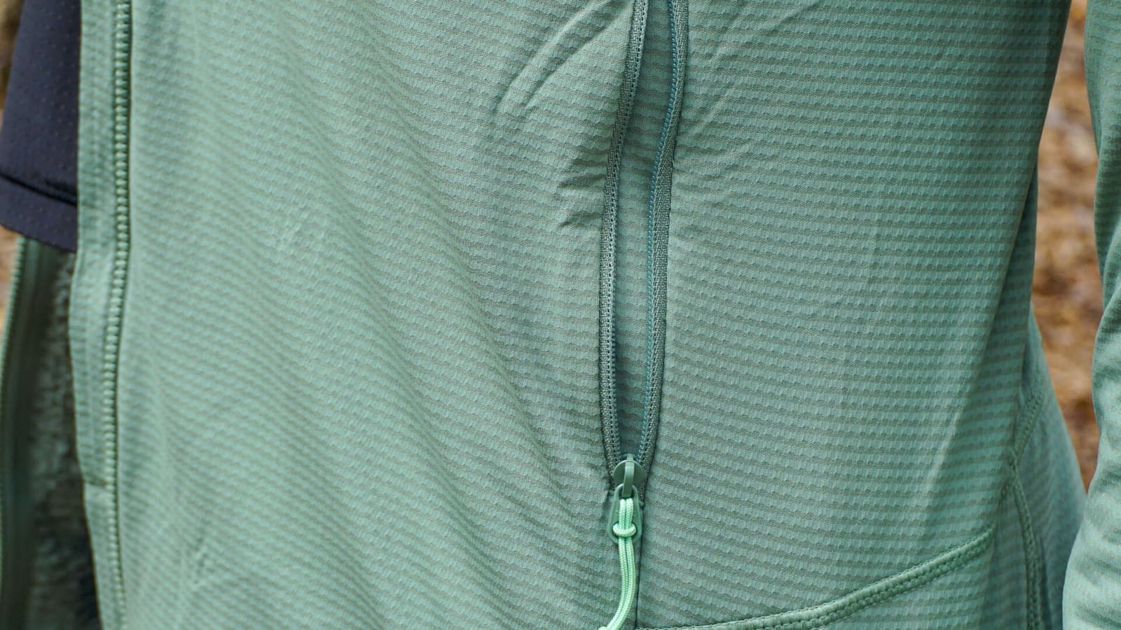A close-up of a zippered pocket on a fleece jacket