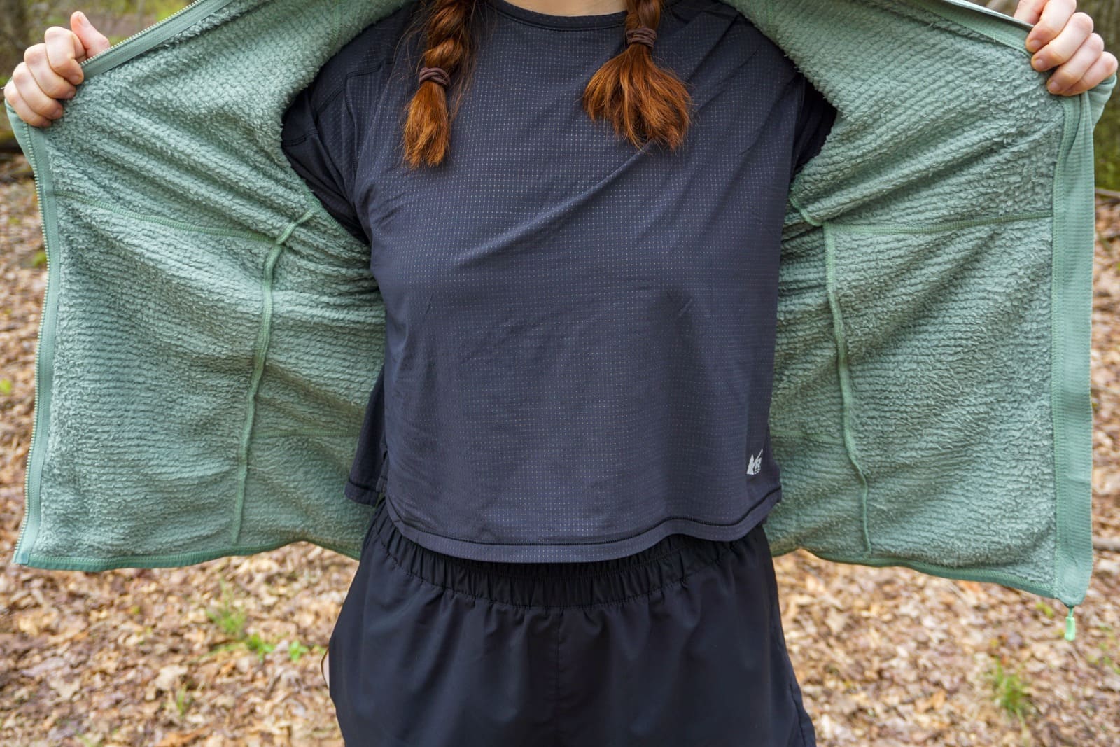 Woman showing off the inside of a fuzzy jacket