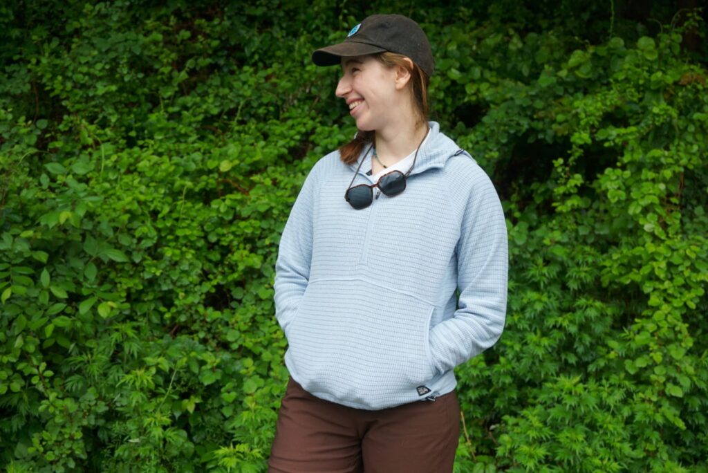 Woman laughs while posing in jacket