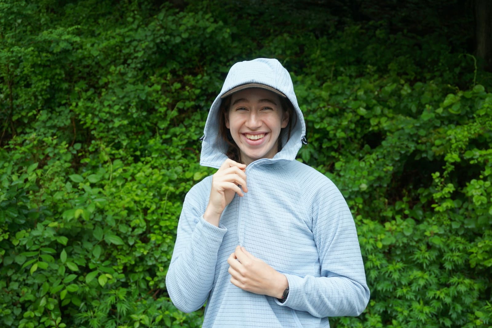 Woman zips up fleece jacket
