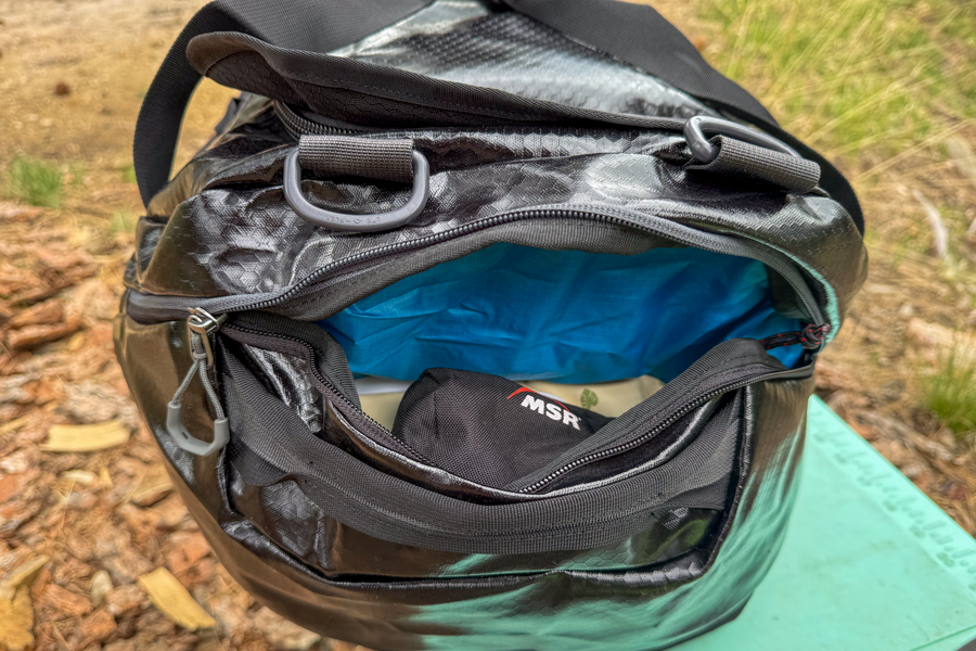 Gregory Alpaca 60 duffel with the expandable end pocket open and packed with gear.
