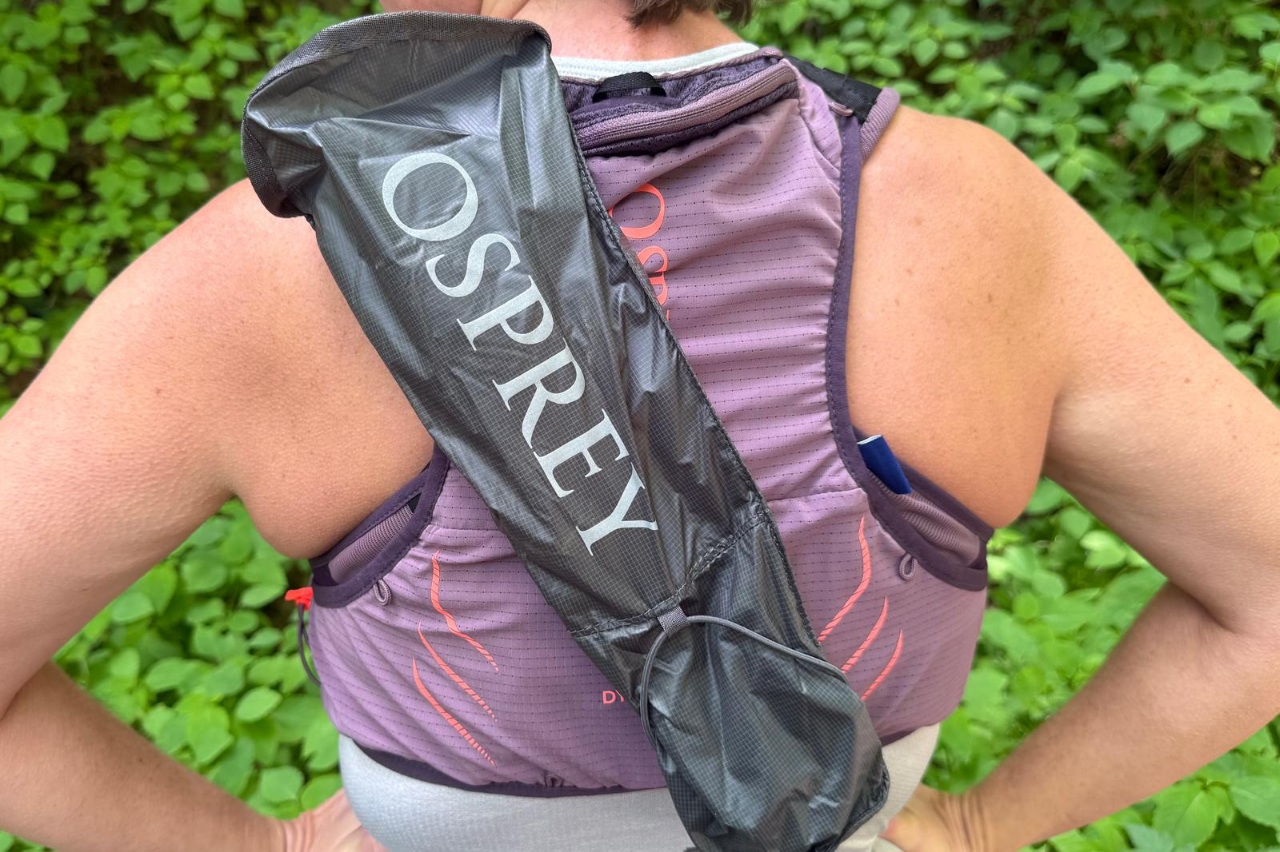 Close-up of a pole quiver on a purple running vest. The quiver is mounted diagonally across the back of the vest.