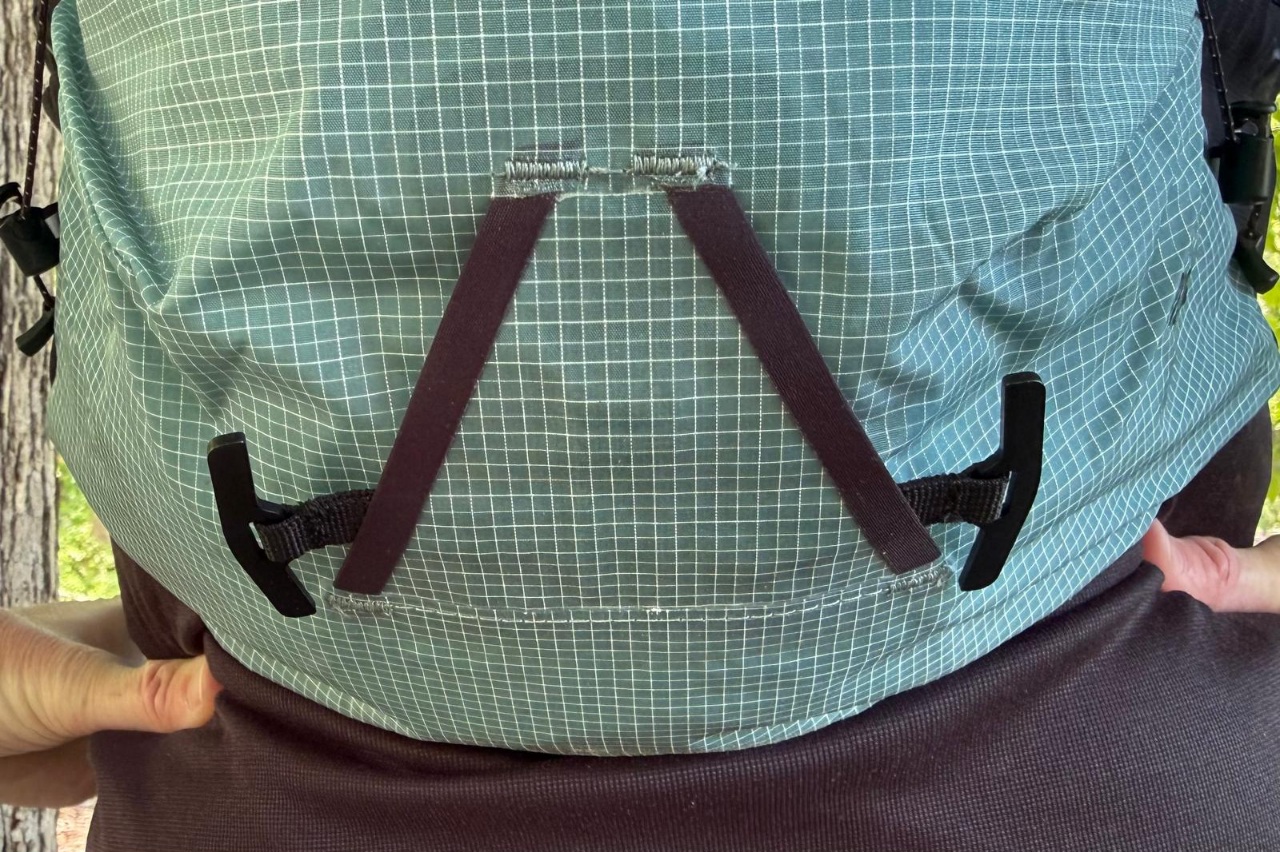 Close-up image of ice axe attachments at the back of a day pack/running vest.