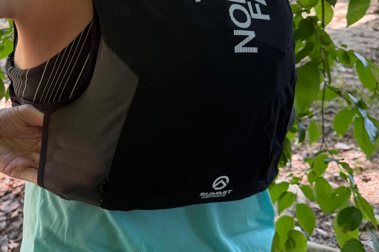 Close-up of the lumbar pocket on a black running vest.
