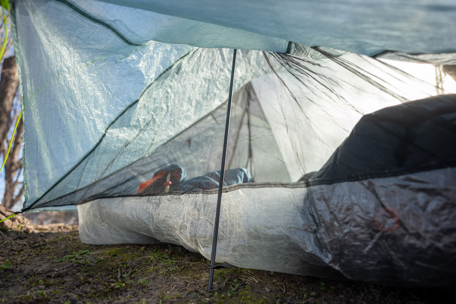 A tent pole holding up the foot end of a tent