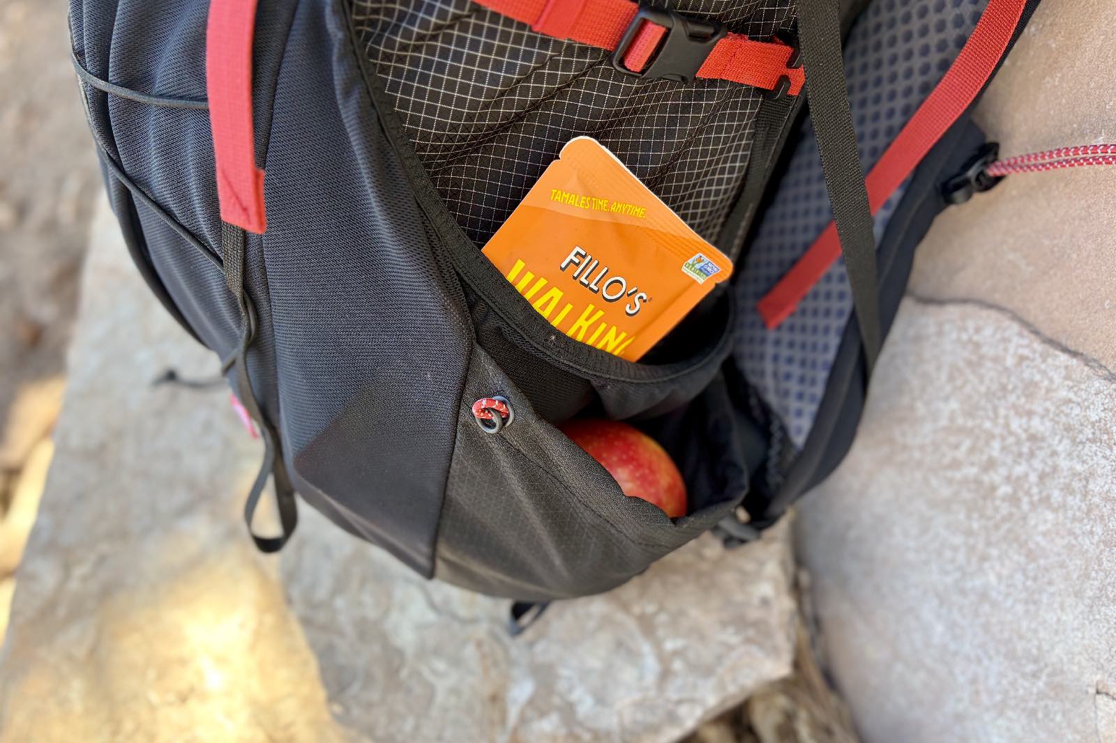 A close up of the double layered side pockets on a backpack.