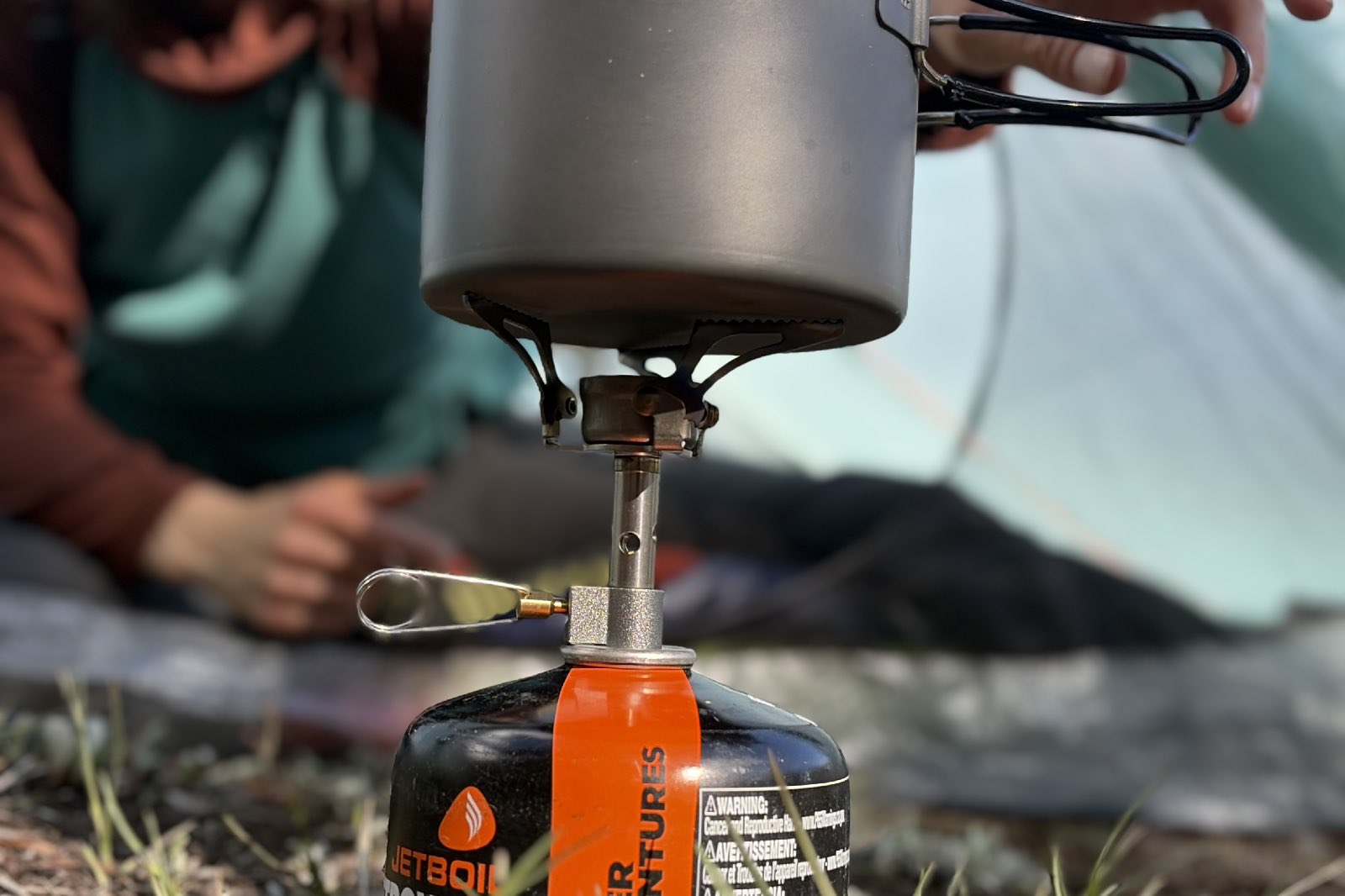 Close-up image of a backpacking stove with a pot on it.