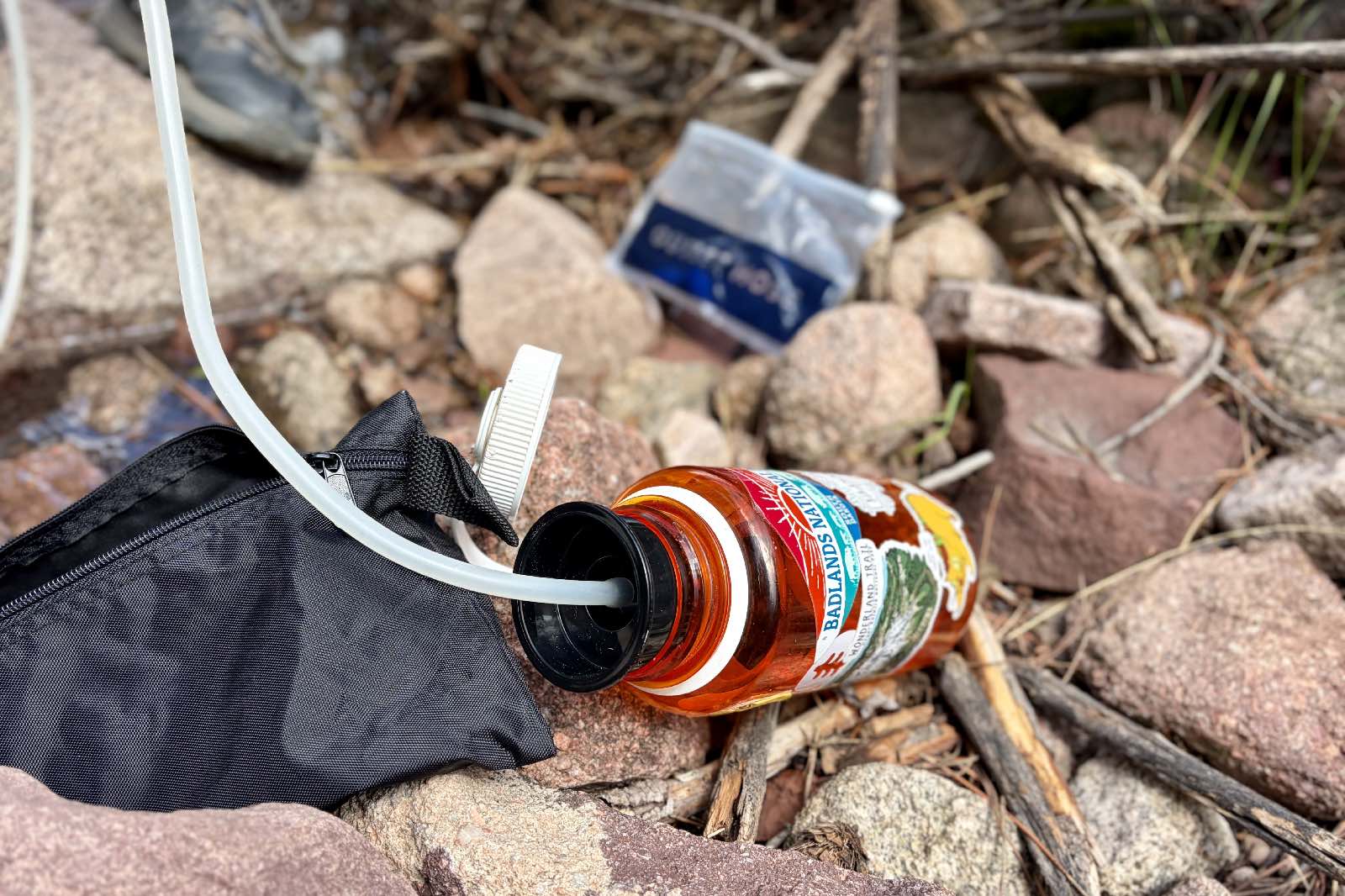 Close-up image of a hose going into a Nalgene bottle.