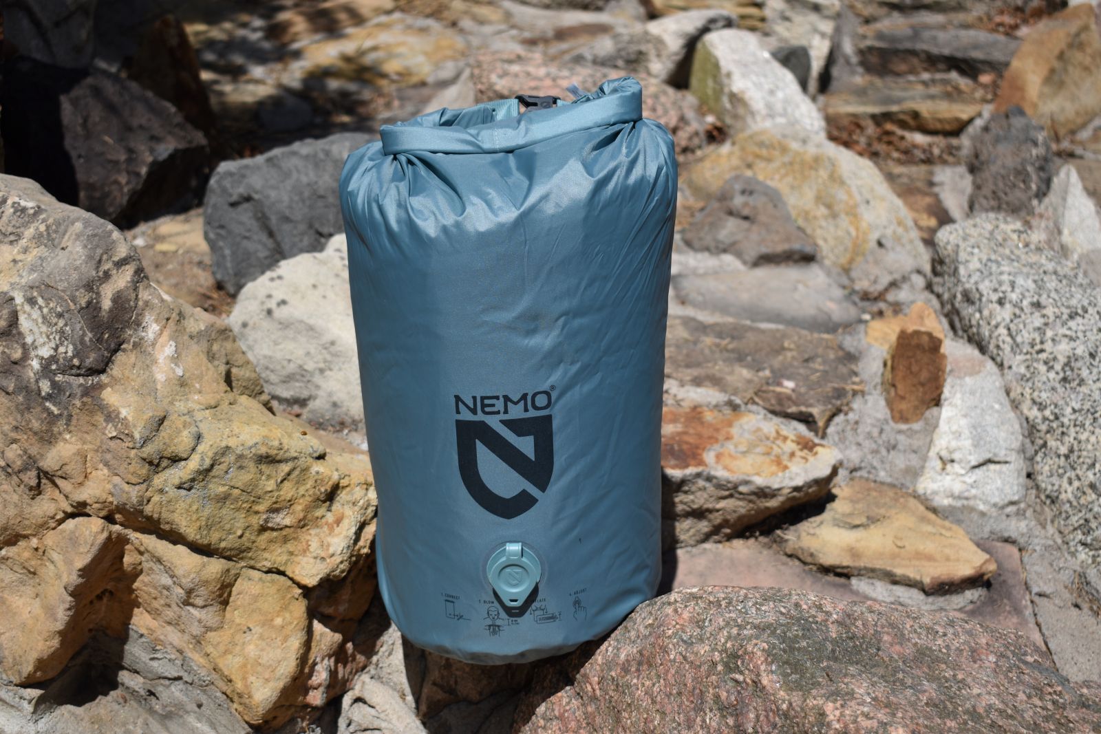 Close up of blue-gray stuff sack sitting on a rock feature