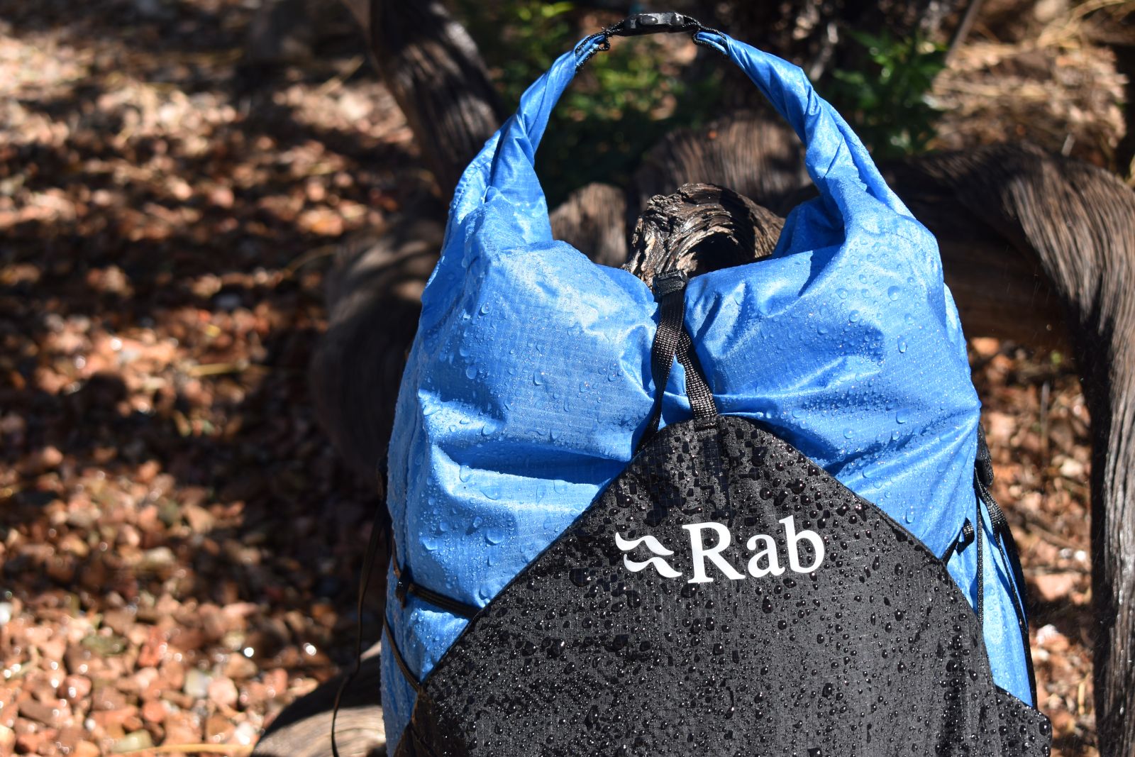 Close up of the roll-top of the waterproof Rab Syclon XP, which is dripping with moisture.