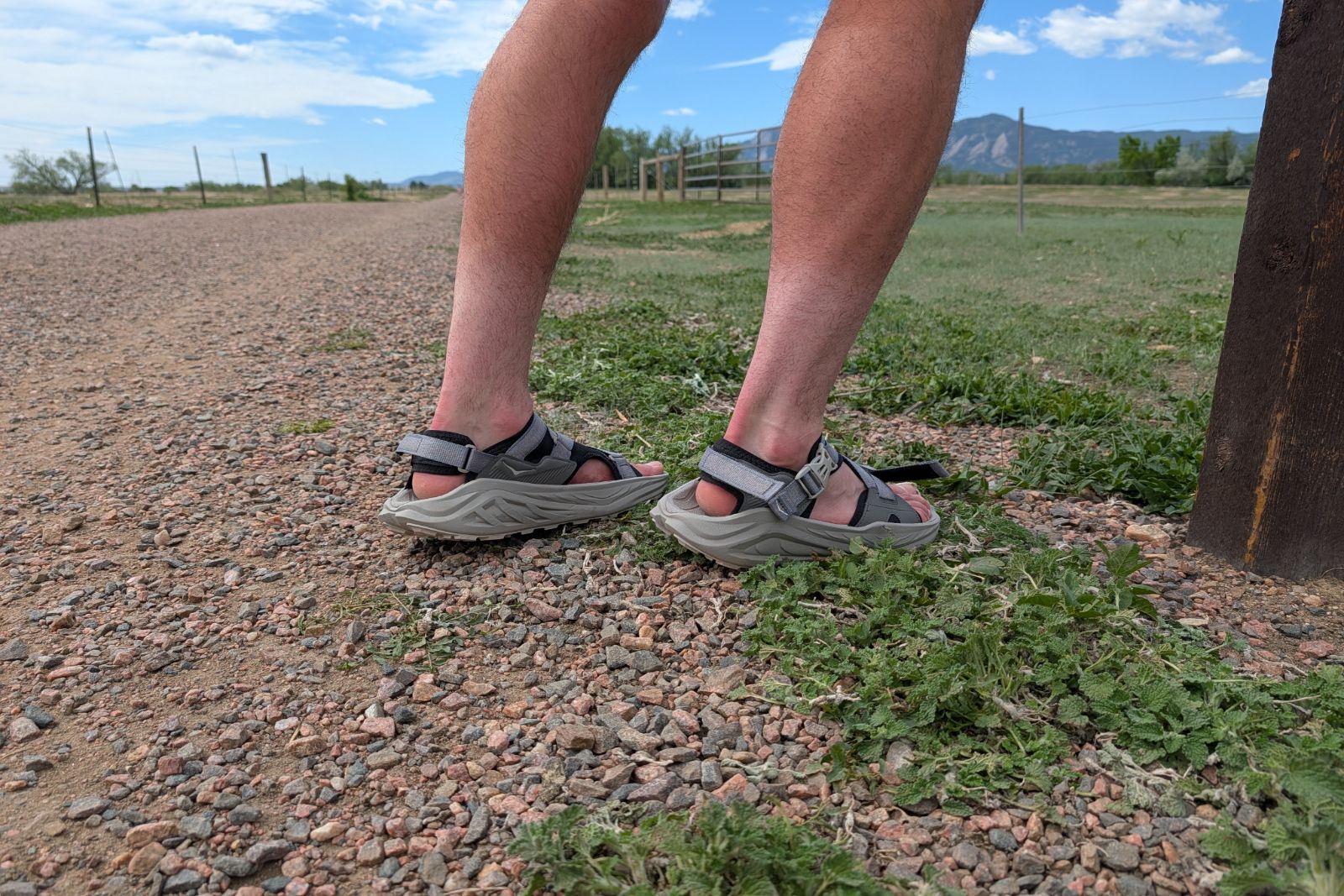 Sockless with the Hoka Infini Hike TC sandals on an easy trail.