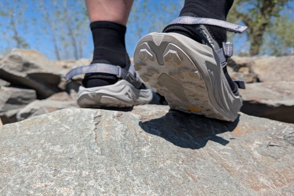 Showing the Hoka Infini Hike TC Vibram outsole on a rock.
