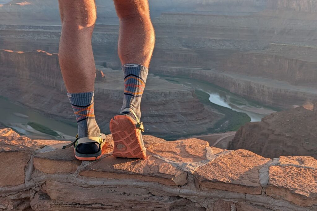 Standing on the edge of a view in Dead Horse Point in the Lems Switchback Knit sandals.