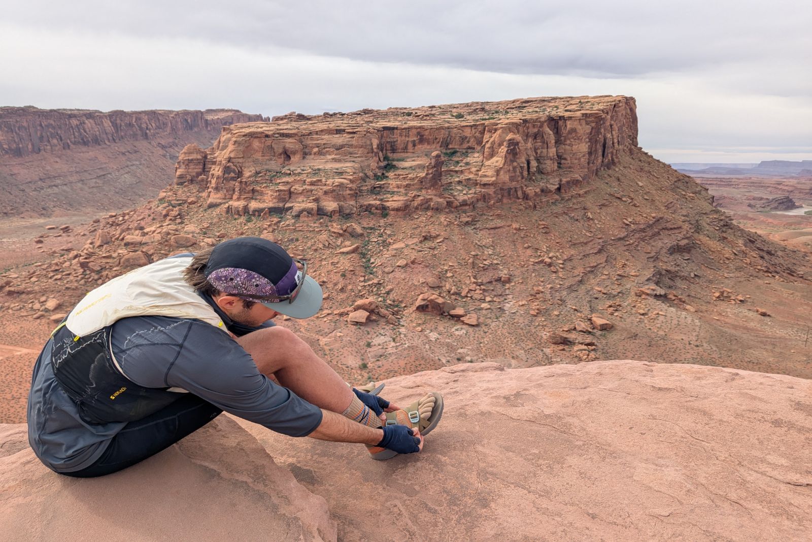 Adjusting the straps of the Tread Lab Redway sandals in Moab Utah.