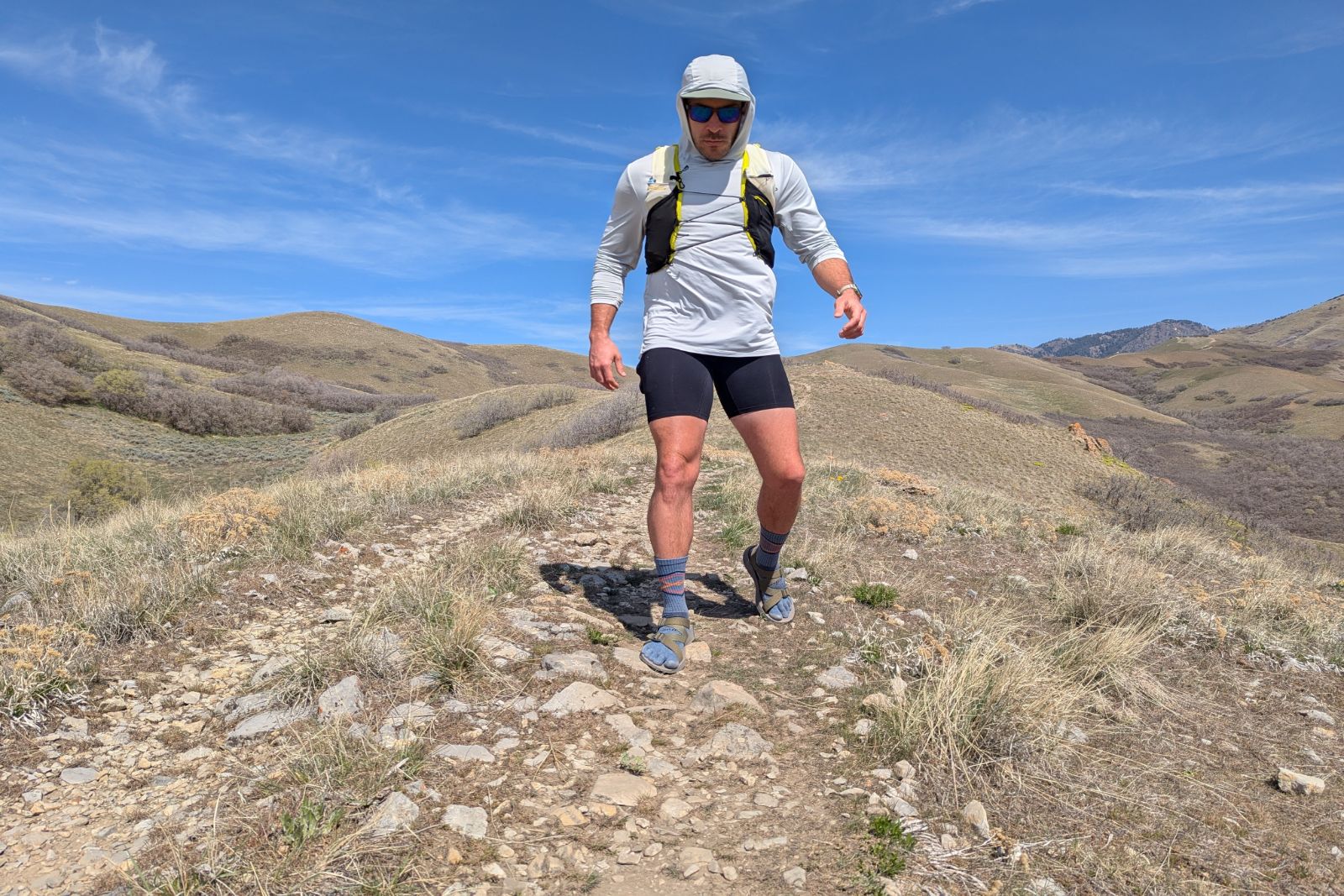 Hiking down a rocky path to test the stability of the Tread Lab Redway sandals.
