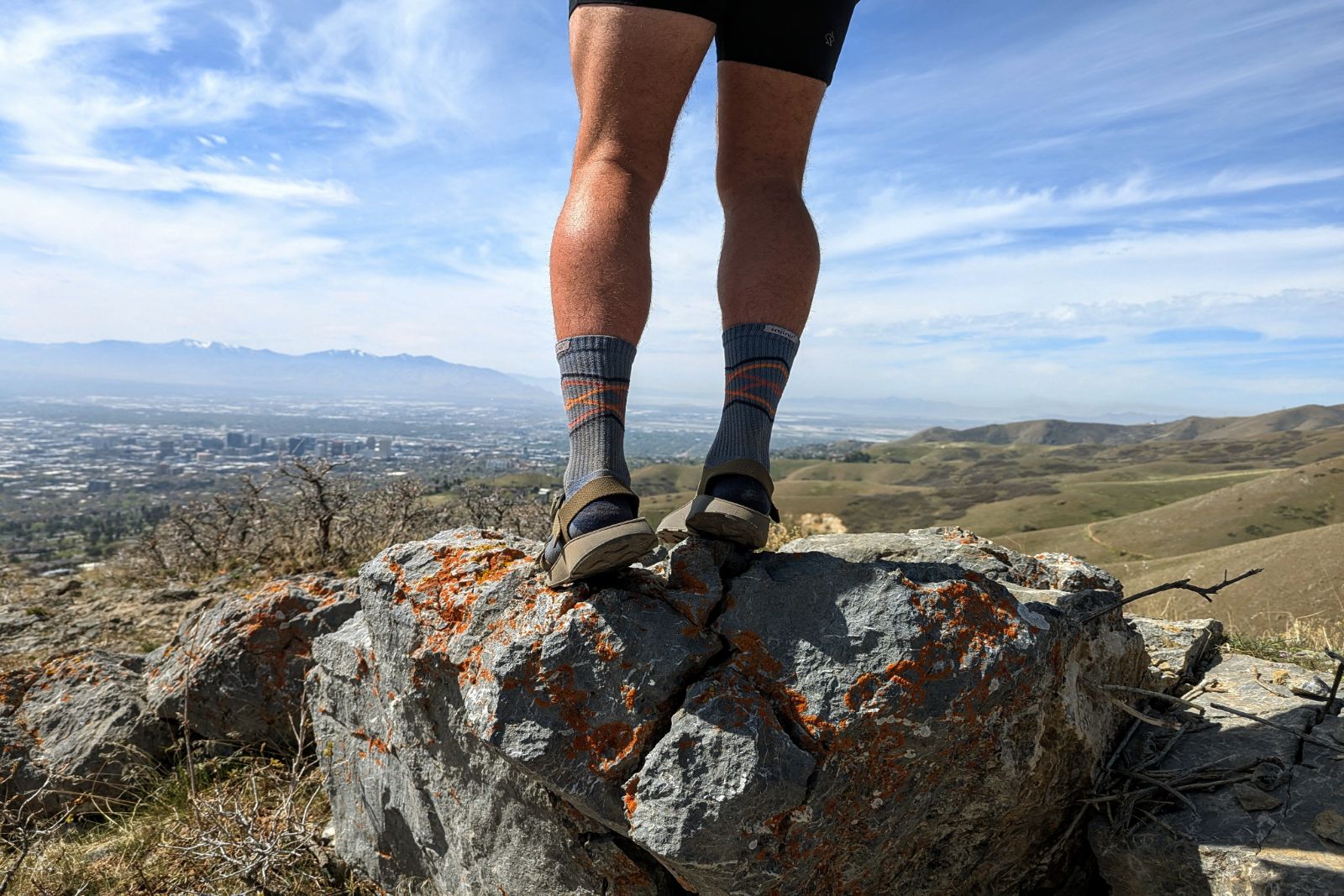 Standing on a boulder overlooking Salt Lake City in the Tread Lab Redway sandals.
