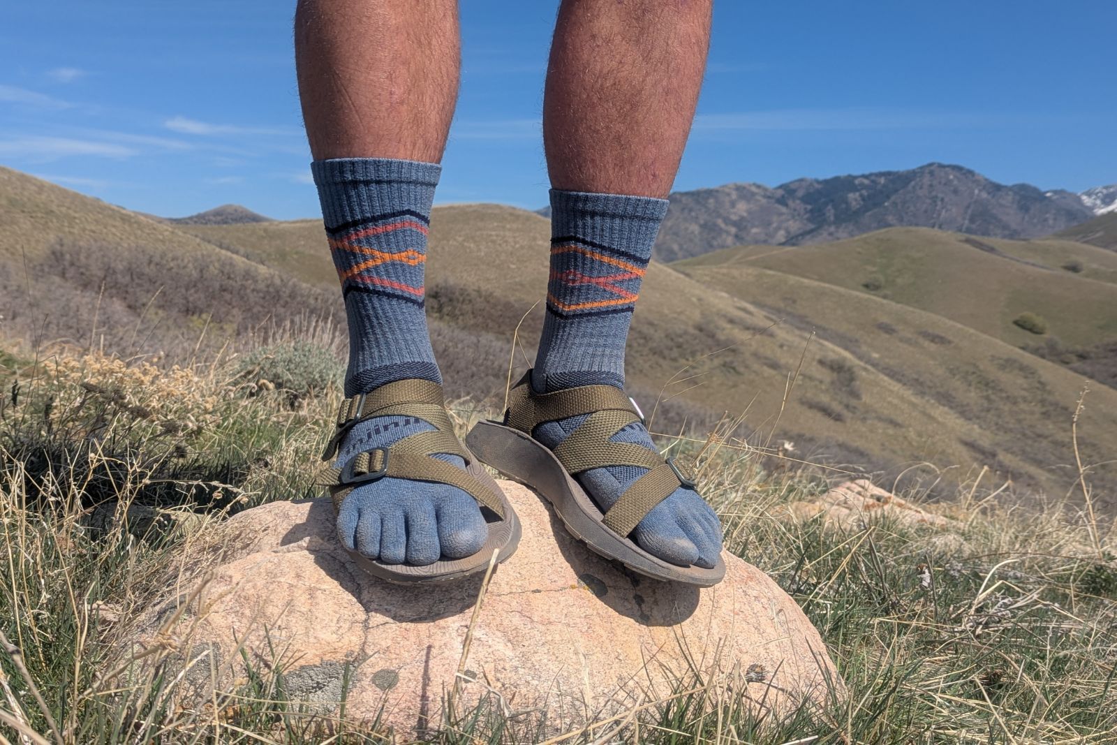 Standing on a boulder in the Tread Lab Redway sandals in Salt Lake City.
