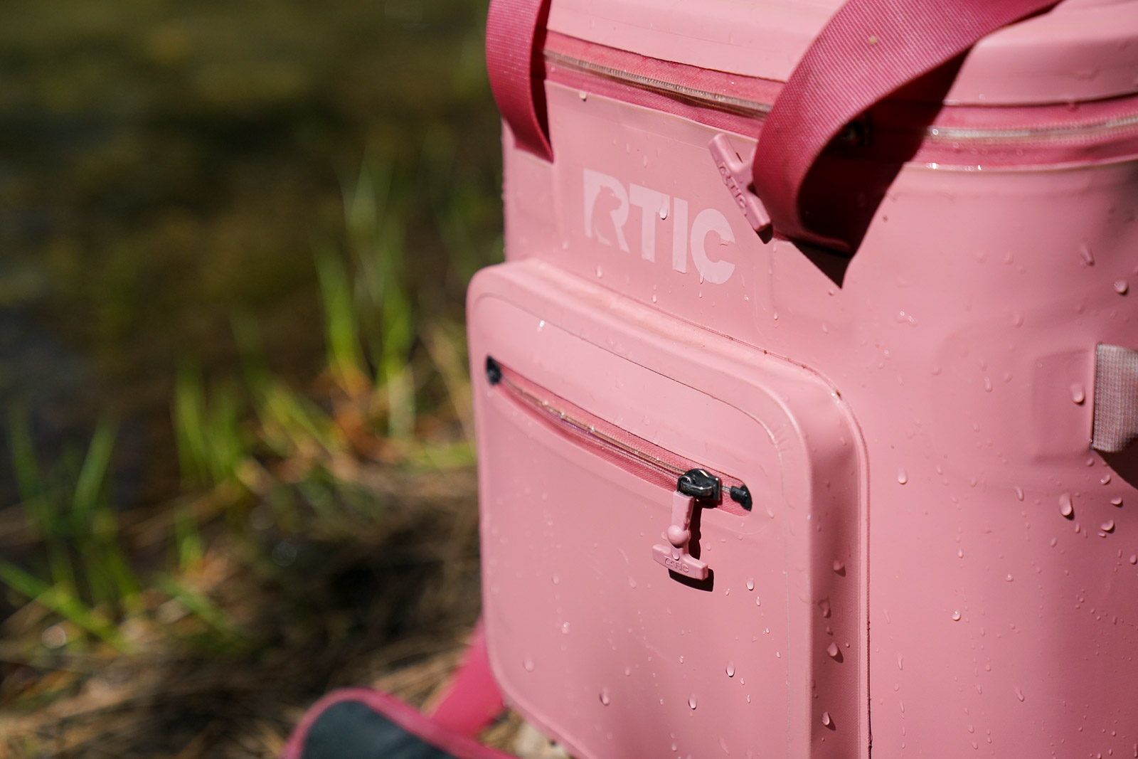 A close up of water beading on the shell of a soft-sided cooler.