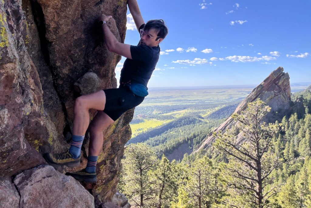 Descending 5th class terrain while wearing a blue fanny pack.