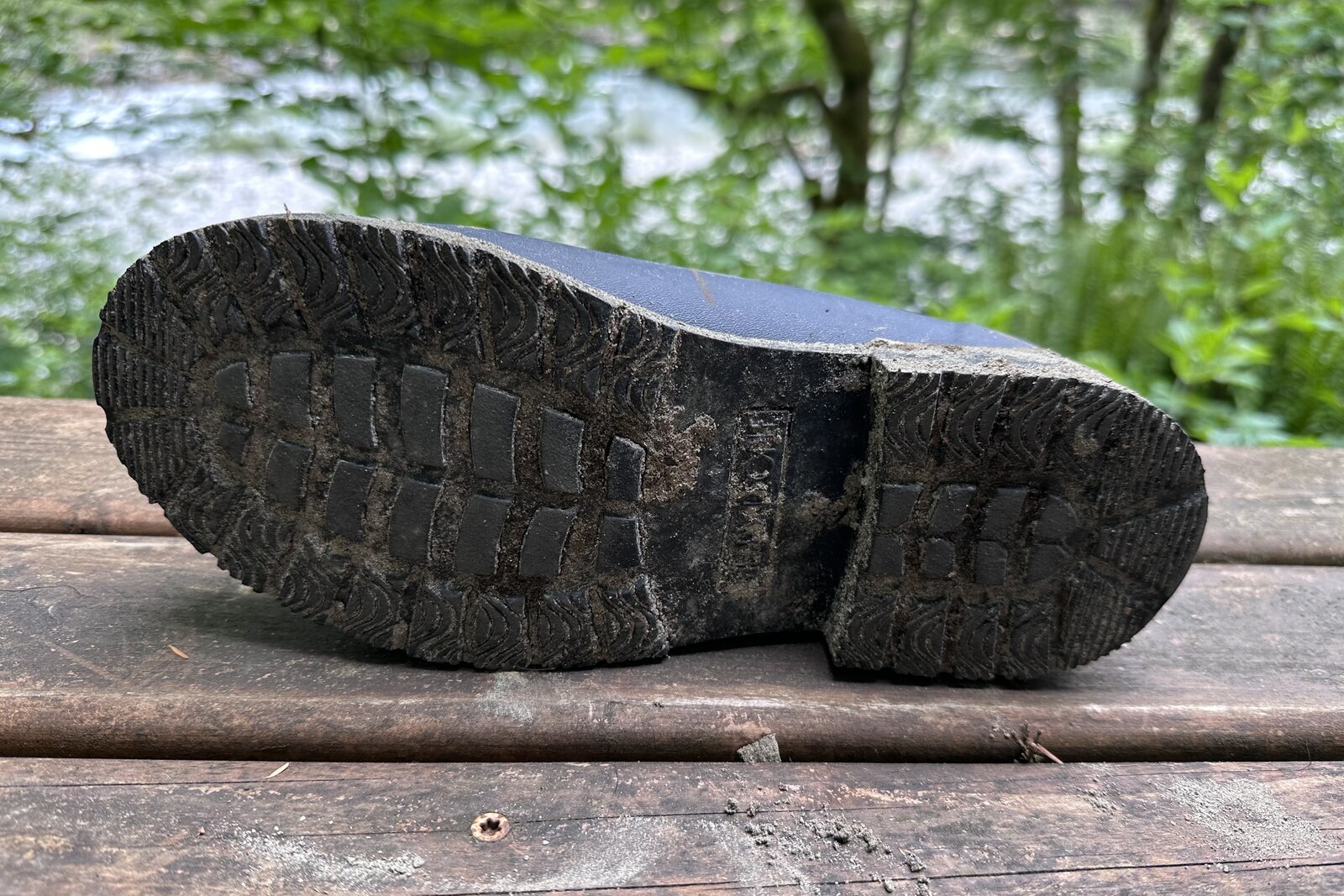 Bottom view of the tread on a pair of rain boots.