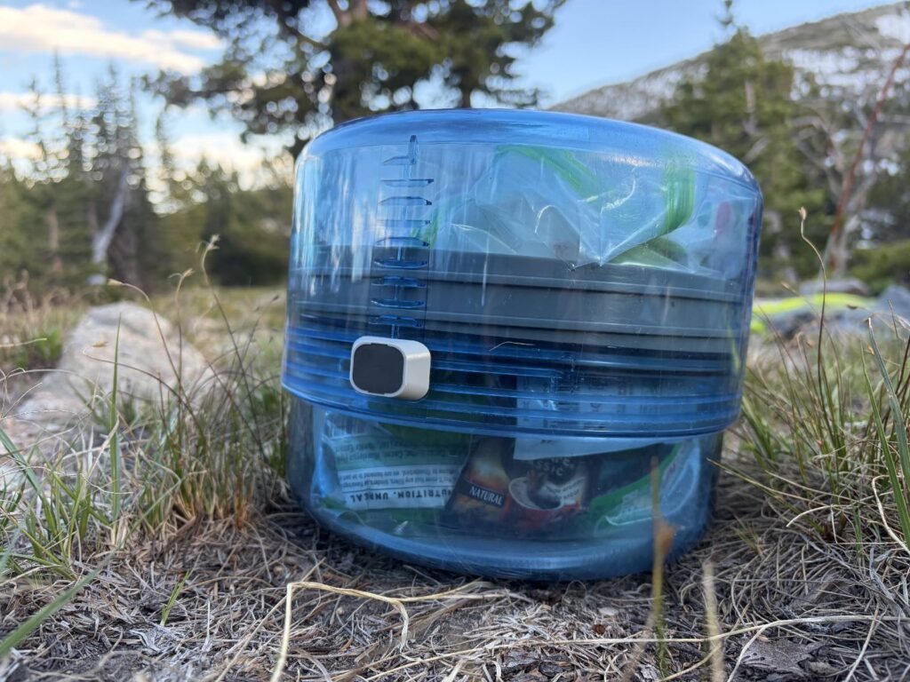 A clear blue bear canister in its smallest size.