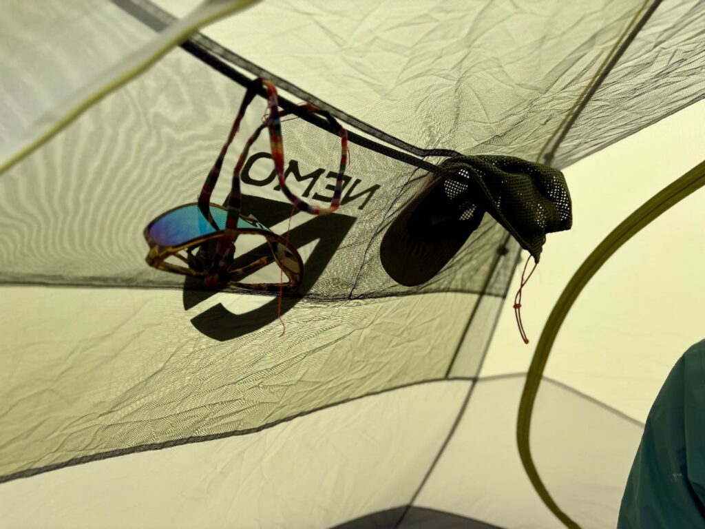 backpacking gear stuffed into the interior gear pockets of a backpacking tent
