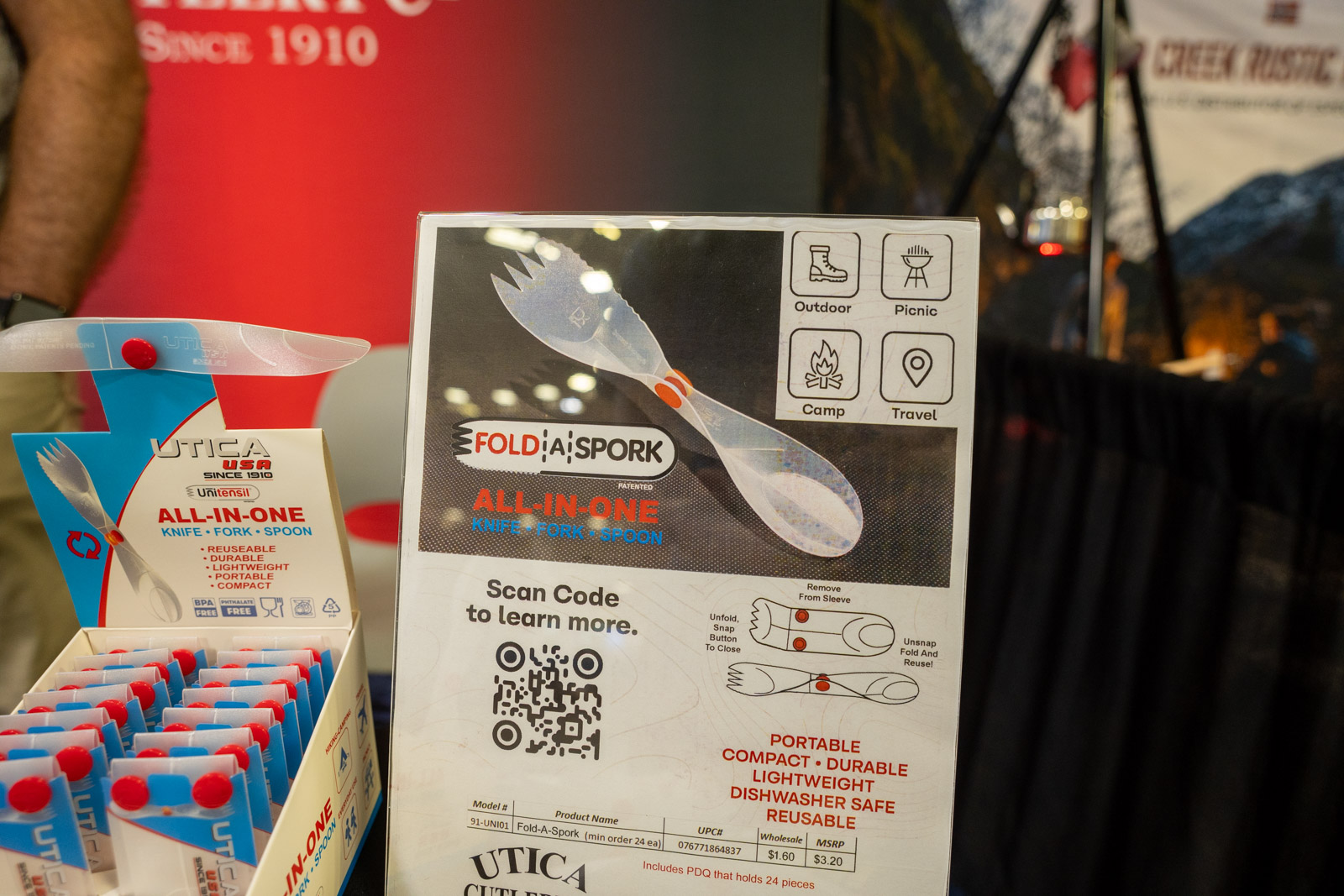 A trade show display for a folding knife and fork made of plastic.