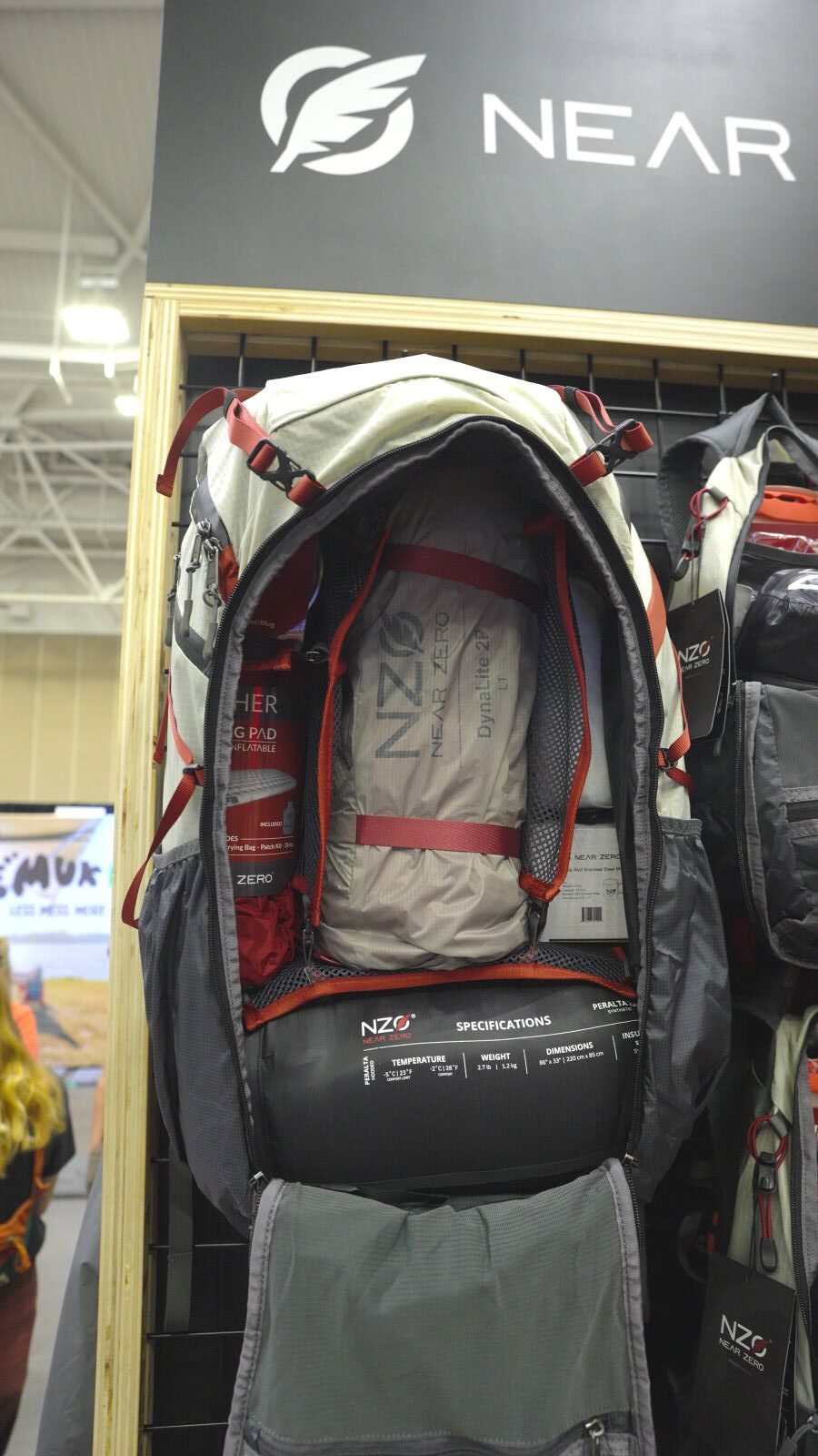 A backpack with its back zipped open shows spaces for items.