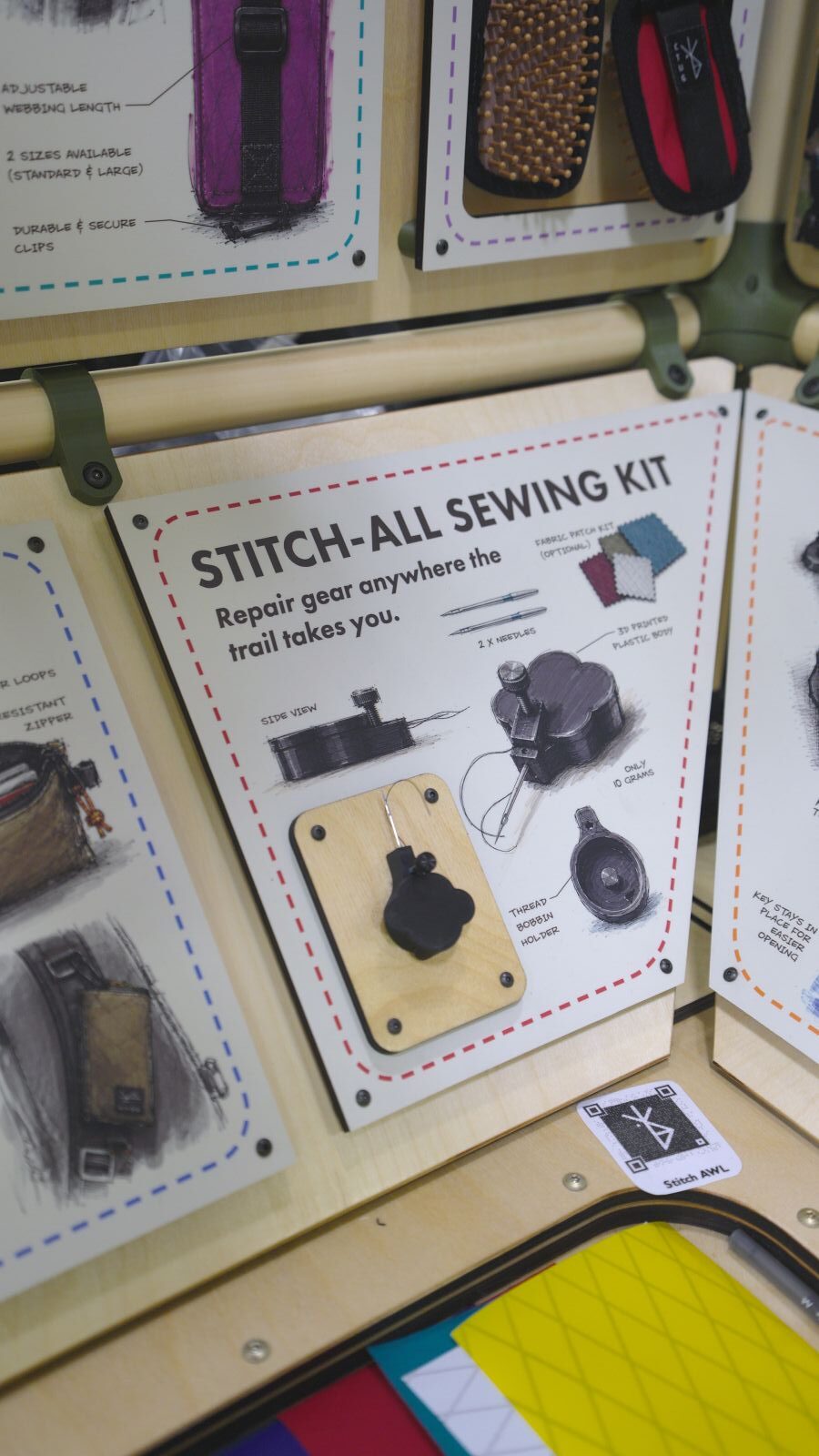 A trade show display of a backpacking sewing repair kit.